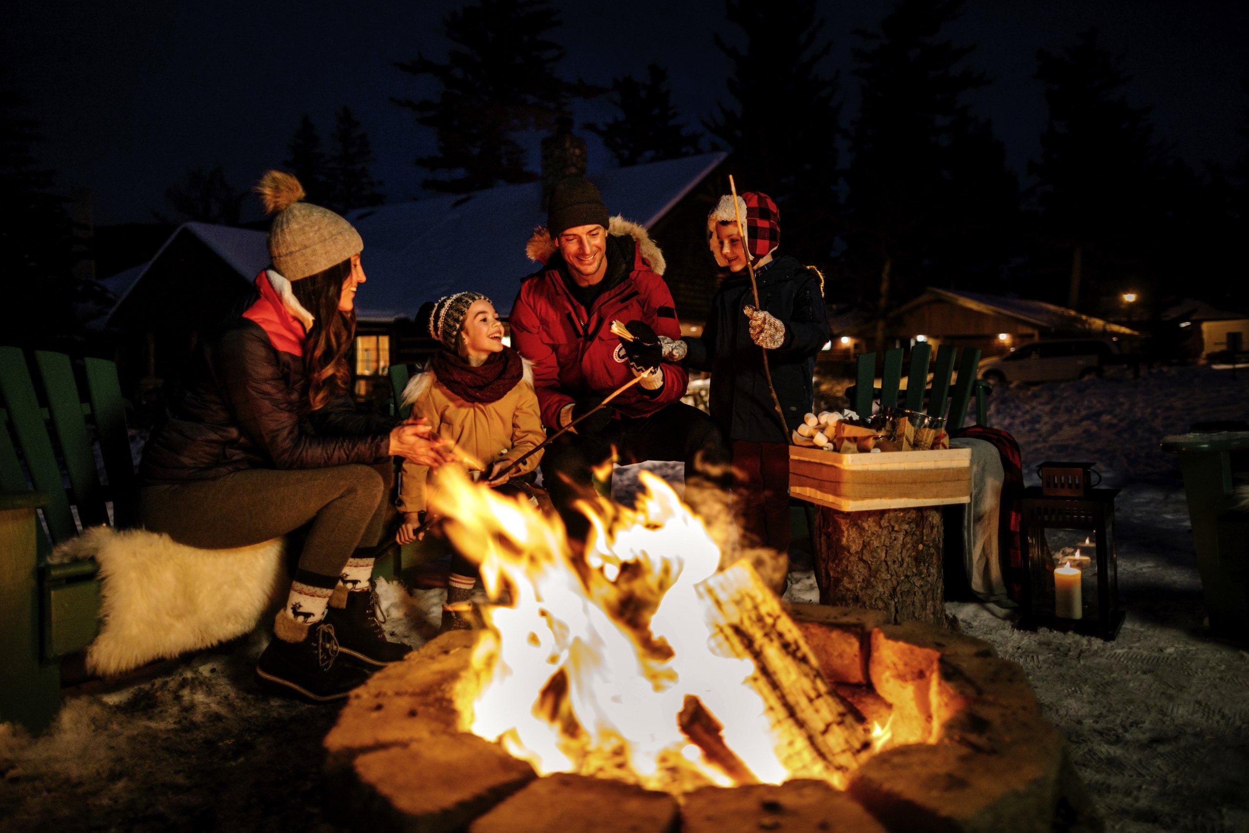 Family enjoying time around a campfire.