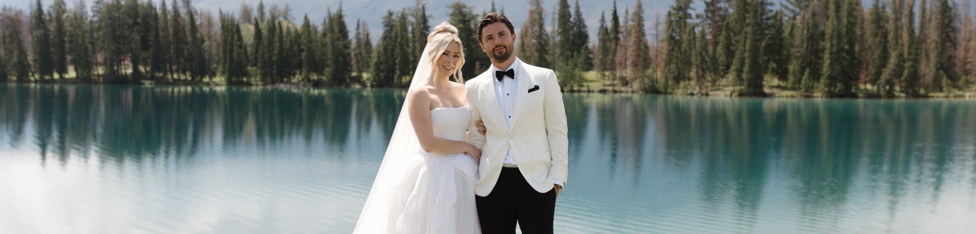 Photo of a bride and groom standing in front of Lac Beauvert