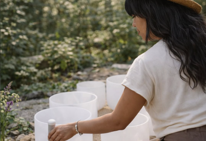 Woman leading a sound bath.