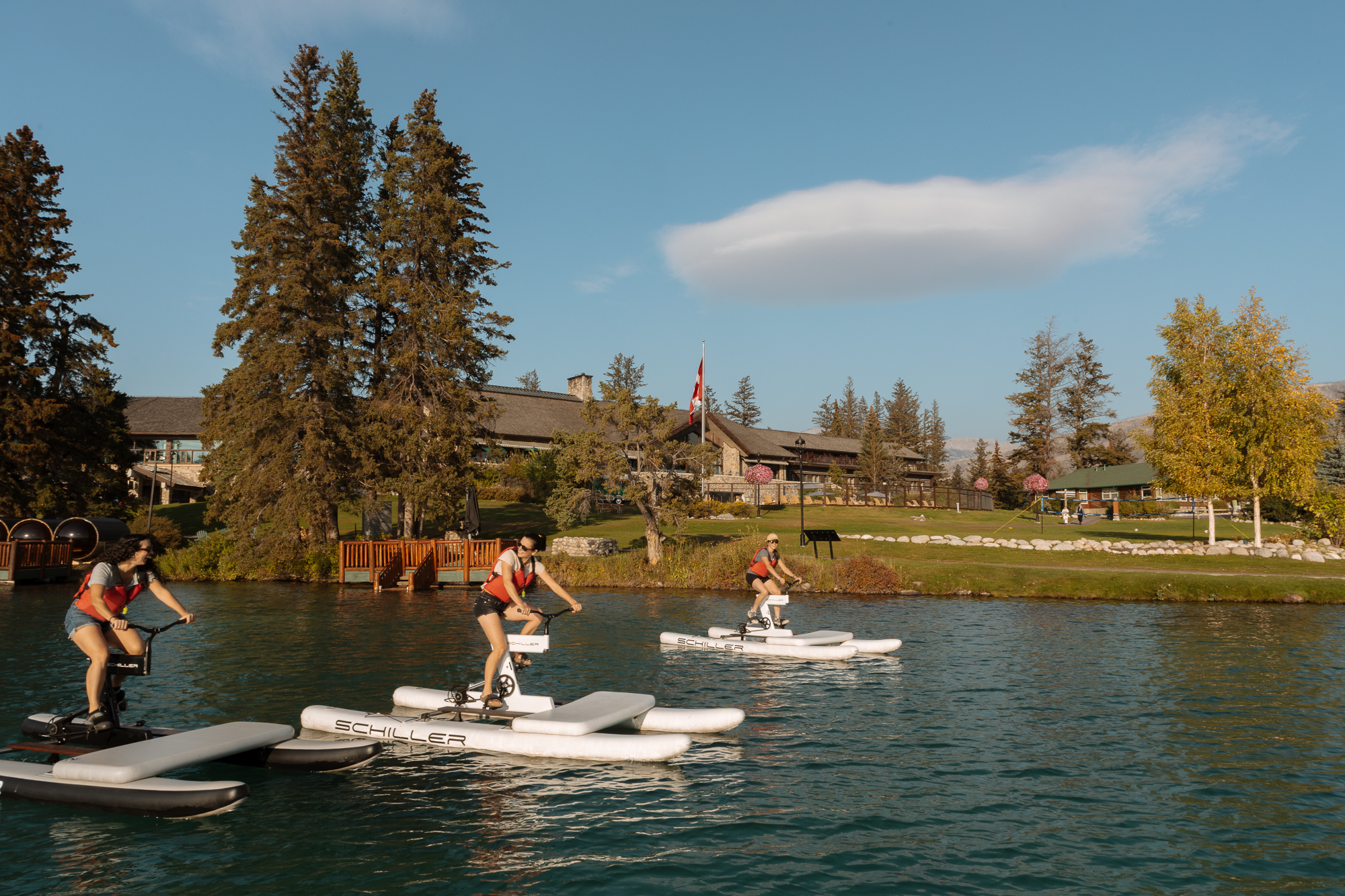 friends riding water bikes on lac beauvert in jasper