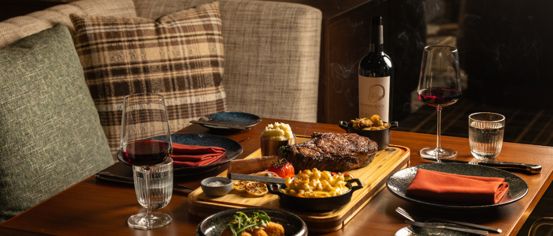 A table filled with food at a steakhouse.