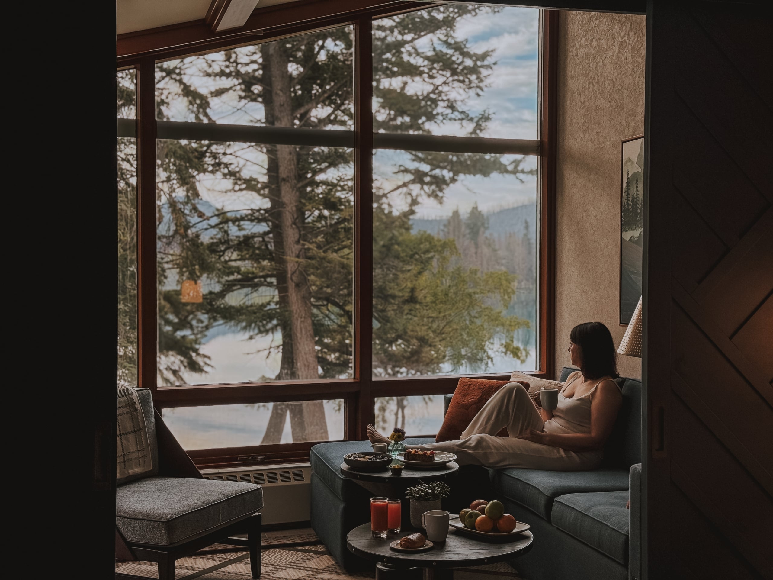 Woman in a suite looking out the window towards Lac Beauvert