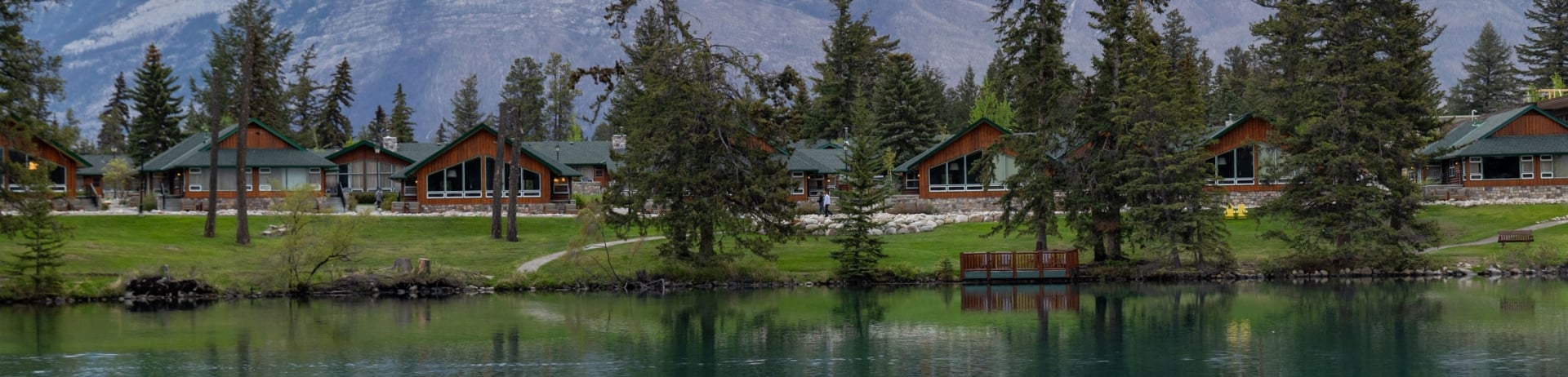 Exterior view of Fairmont Jasper Park cabins as seen from across Lac Beauvert