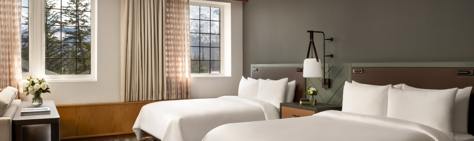 A hotel room with two queen size beds.