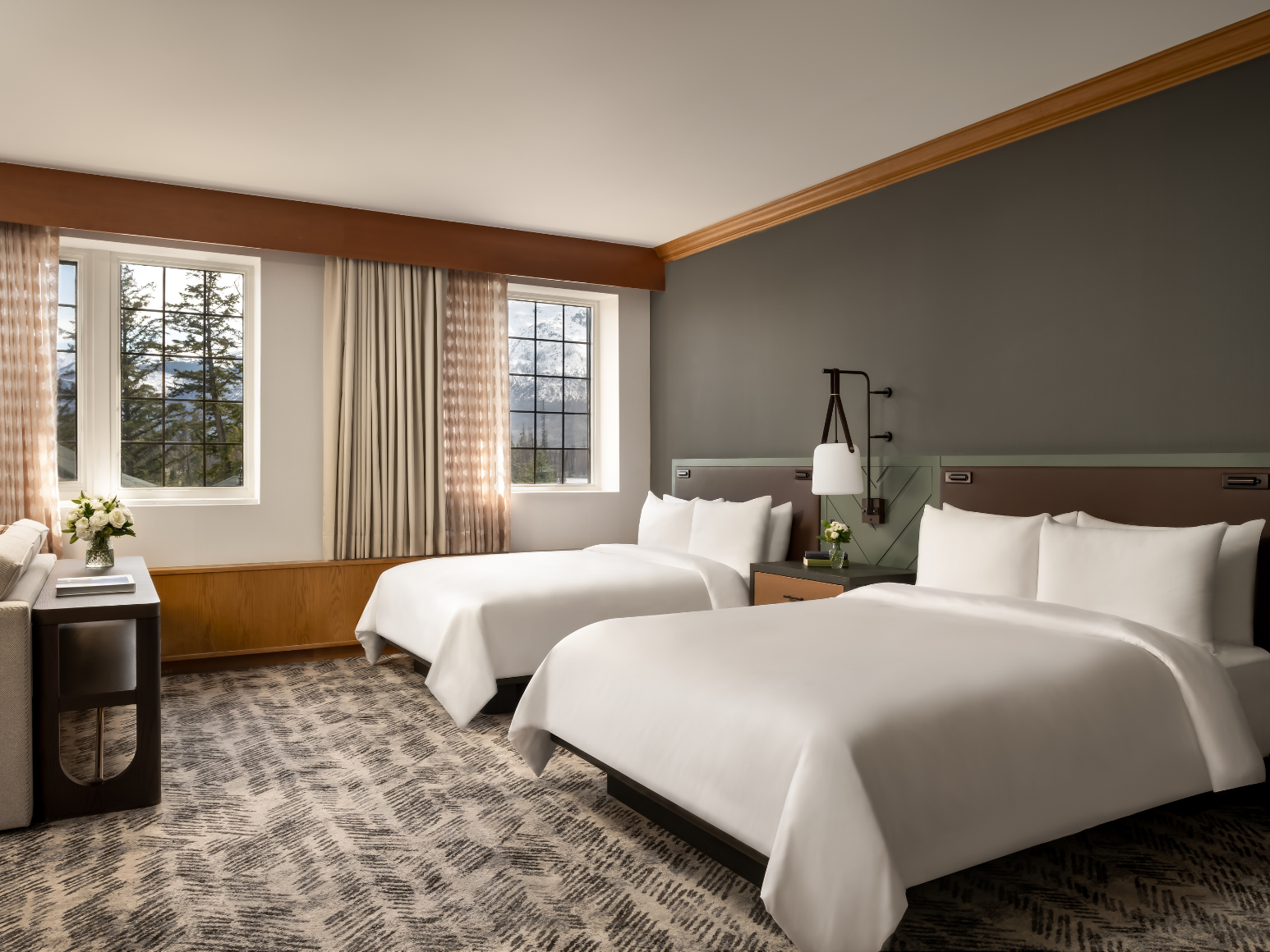 A hotel room with two queen size beds.