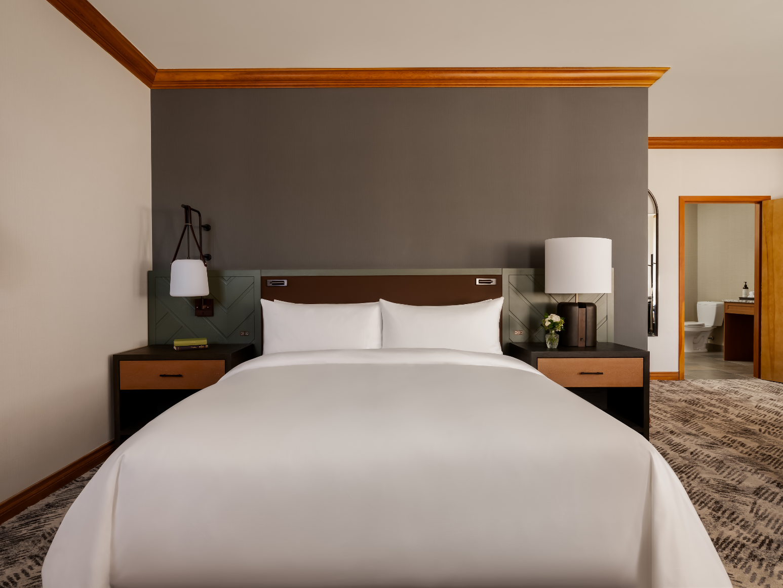 A hotel room with a king size bed.