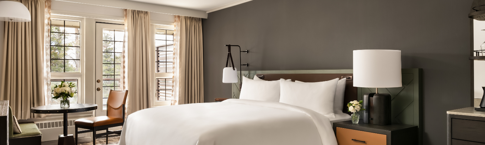 A hotel room with a king size bed.