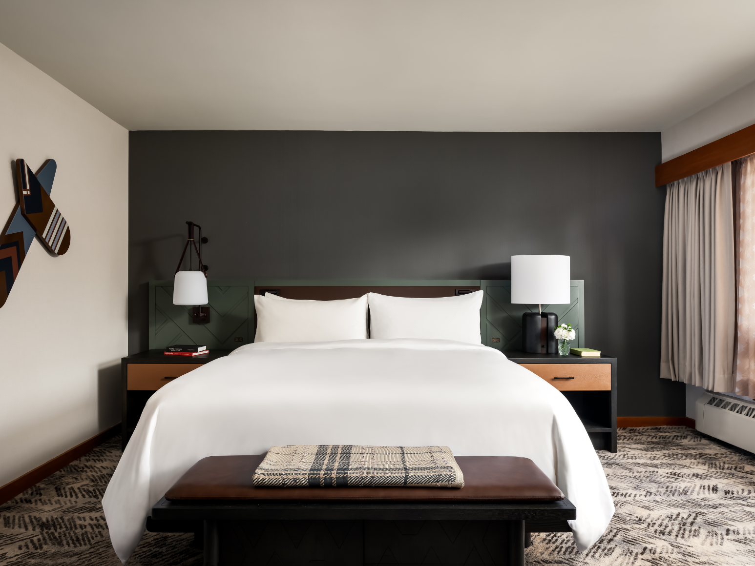 A hotel room with a king size bed.