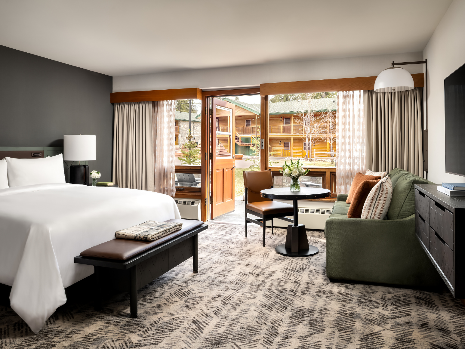 A hotel room with a king size bed.