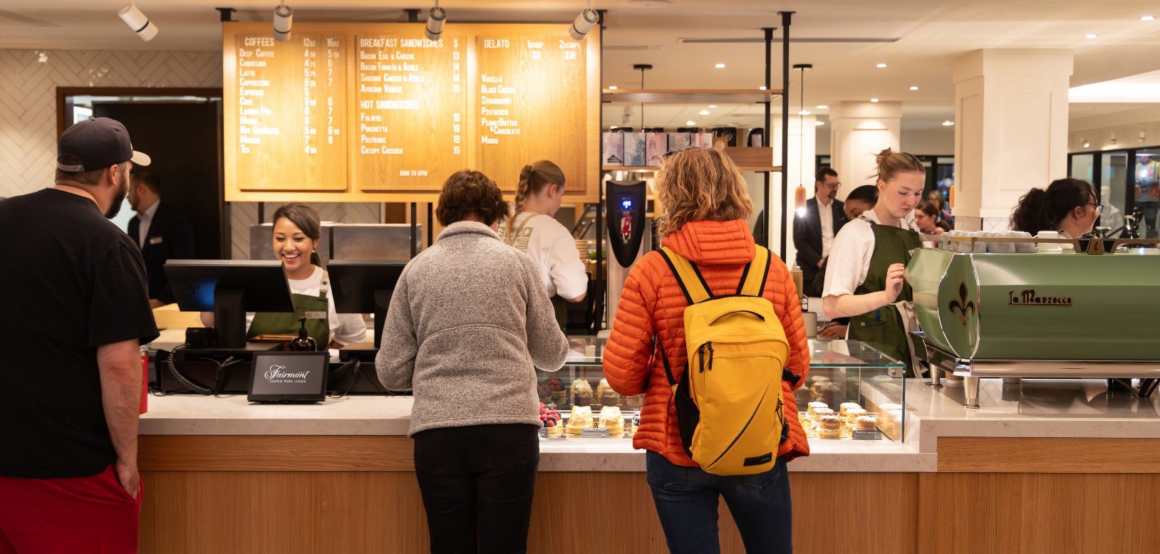 Ordering coffee with a backpack.