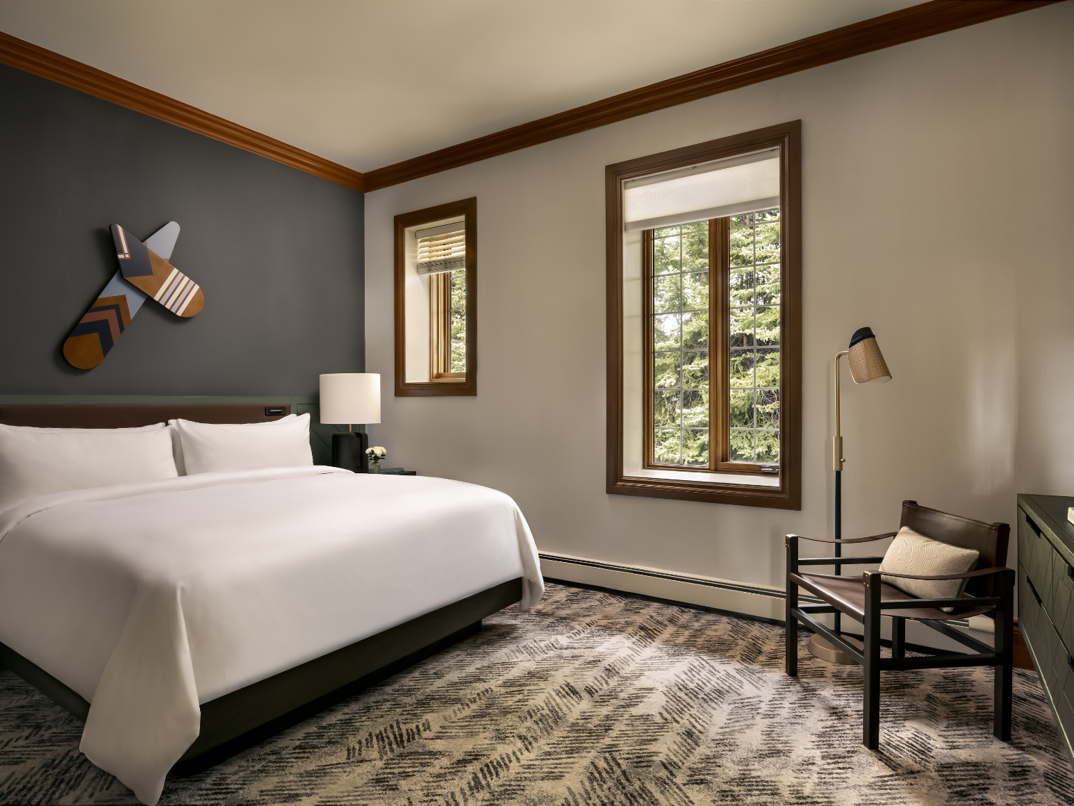 A hotel room with a bed.