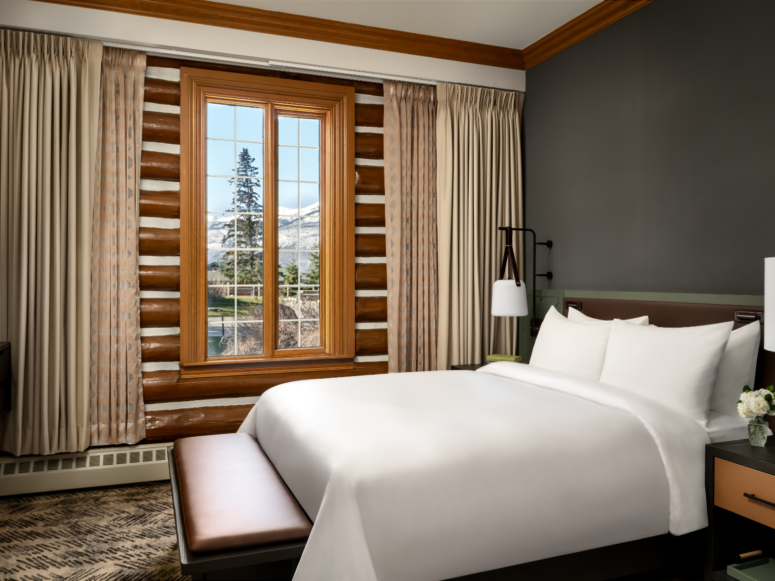 A hotel room with a king size bed.
