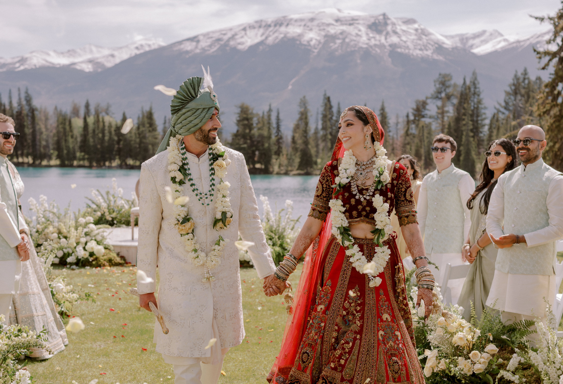 A happy couple celebrating their outdoor wedding with a mountain view.