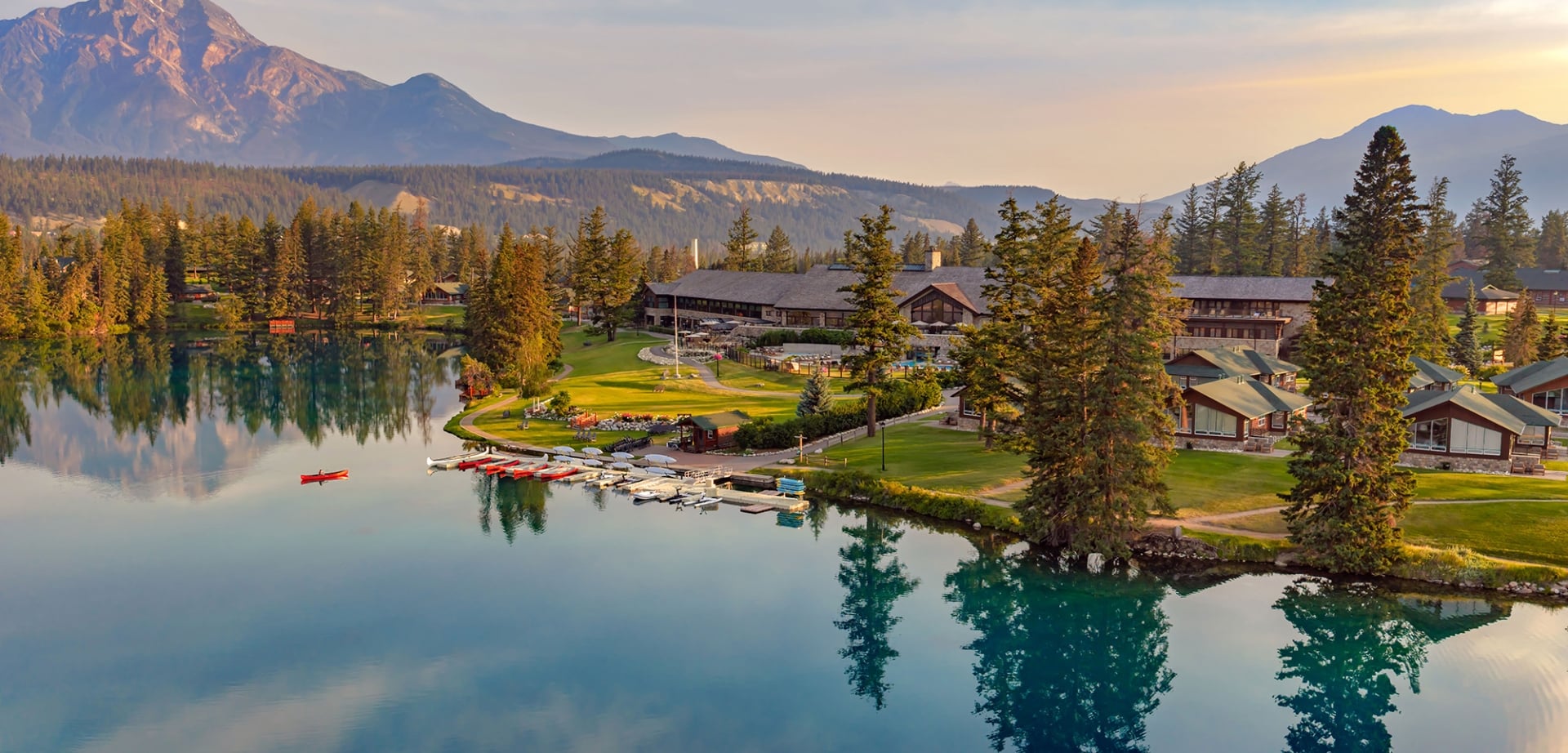 Aerial view of Fairmont Jasper Park Lodge and a canoe on Lac Beauvert.