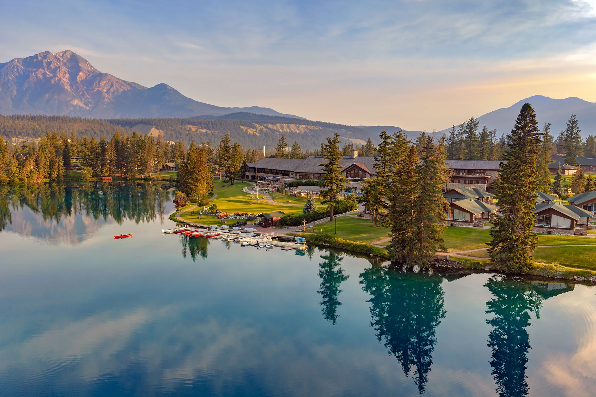 Aerial view of Fairmont Jasper Park Lodge and a canoe on Lac Beauvert.