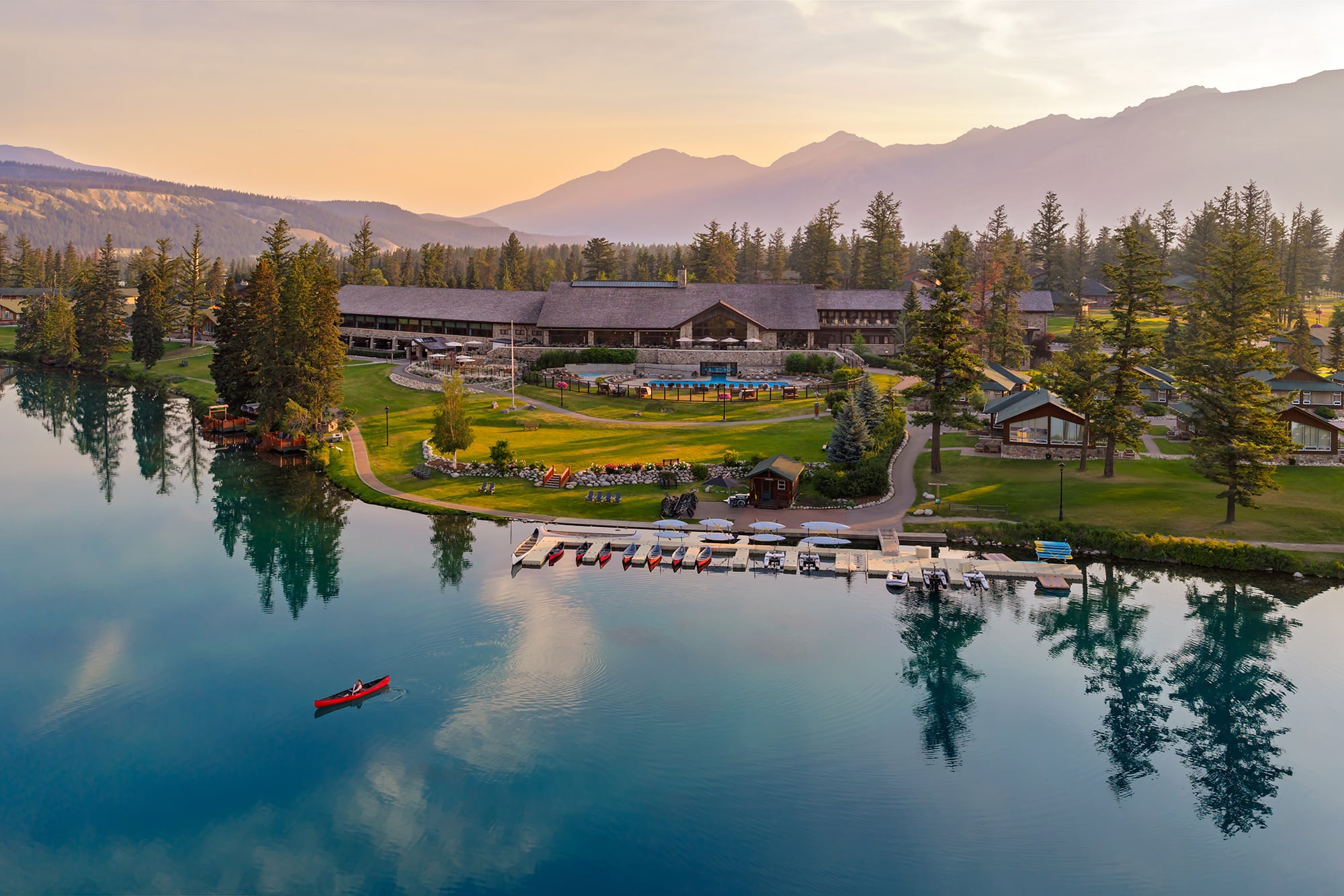 Aerial view of Fairmont Jasper Park Lodge and a canoe on Lac Beauvert.