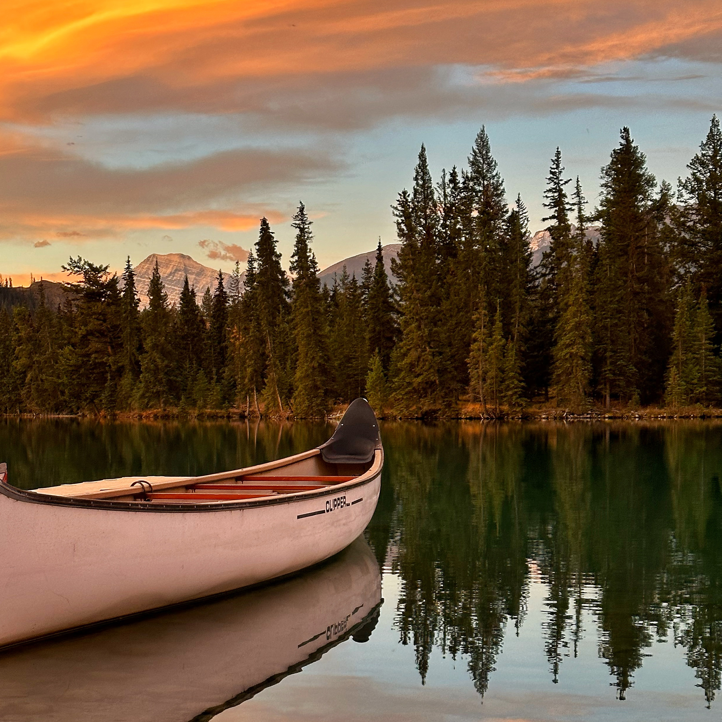 Clipper canoe on Lac Beauvert in the fall. The Boathouse at Fairmont Jasper Park Lodge.